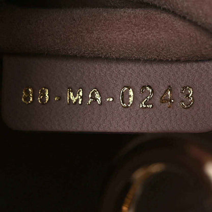 Mini Lady Dior handbag interior date/serial stamp on brown lining near seam.