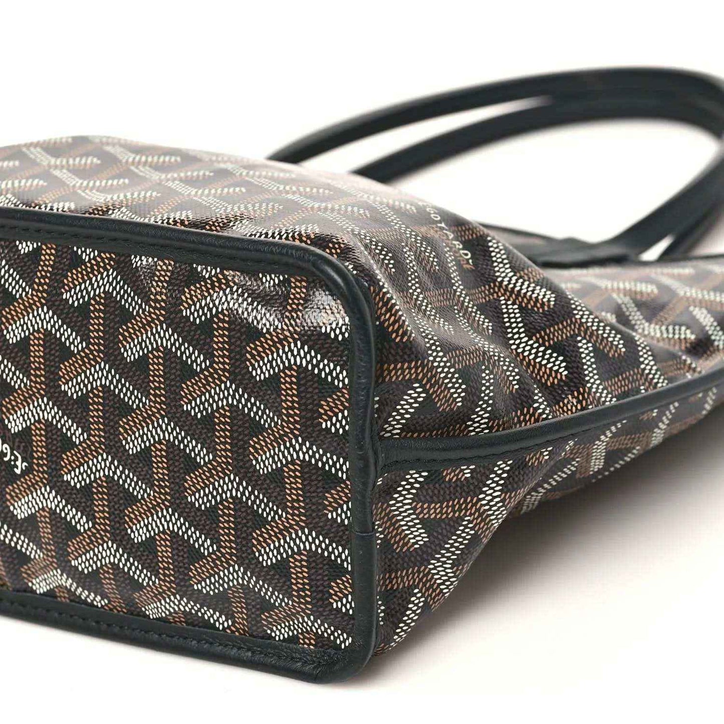 Mini reversible tote bag corner with black strap handles and geometric canvas exterior