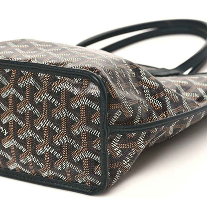 Mini reversible tote bag corner with black strap handles and geometric canvas exterior