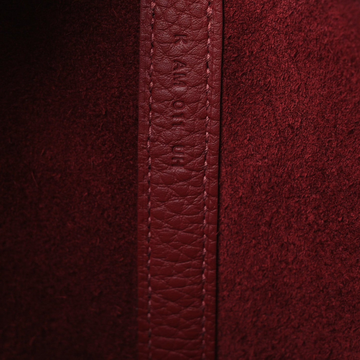 Burgundy grained leather seam with reinforced edge panel