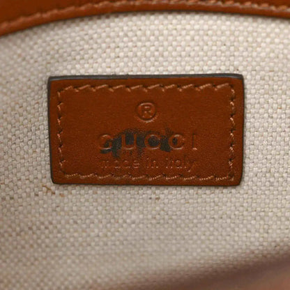 Mini bag leather patch with embossed logo on light canvas background