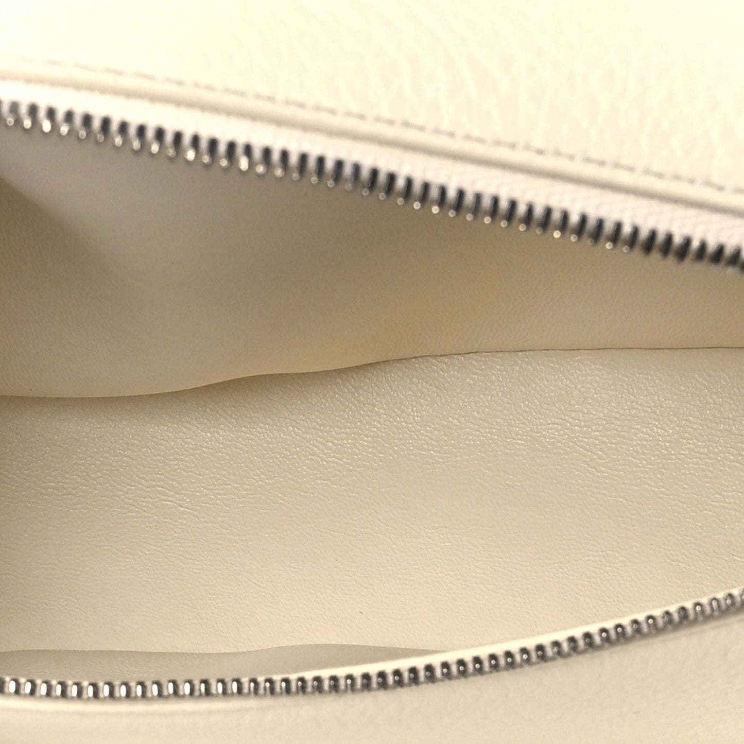 Pouch interior seam and zipper teeth along the top opening