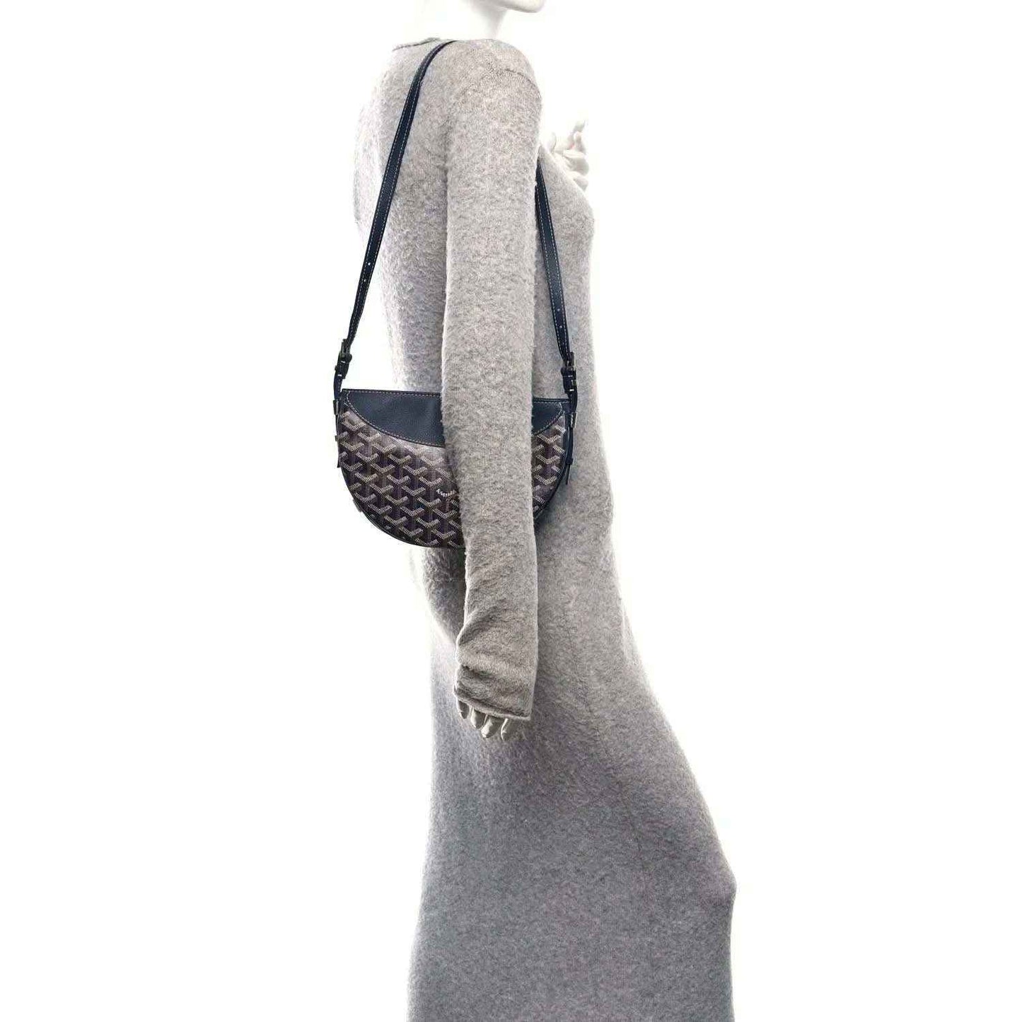 Navy shoulder bag with patterned canvas body and adjustable strap, side view