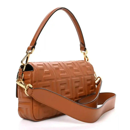 Fendi baguette bag with tan crossbody strap and embossed leather flap closure