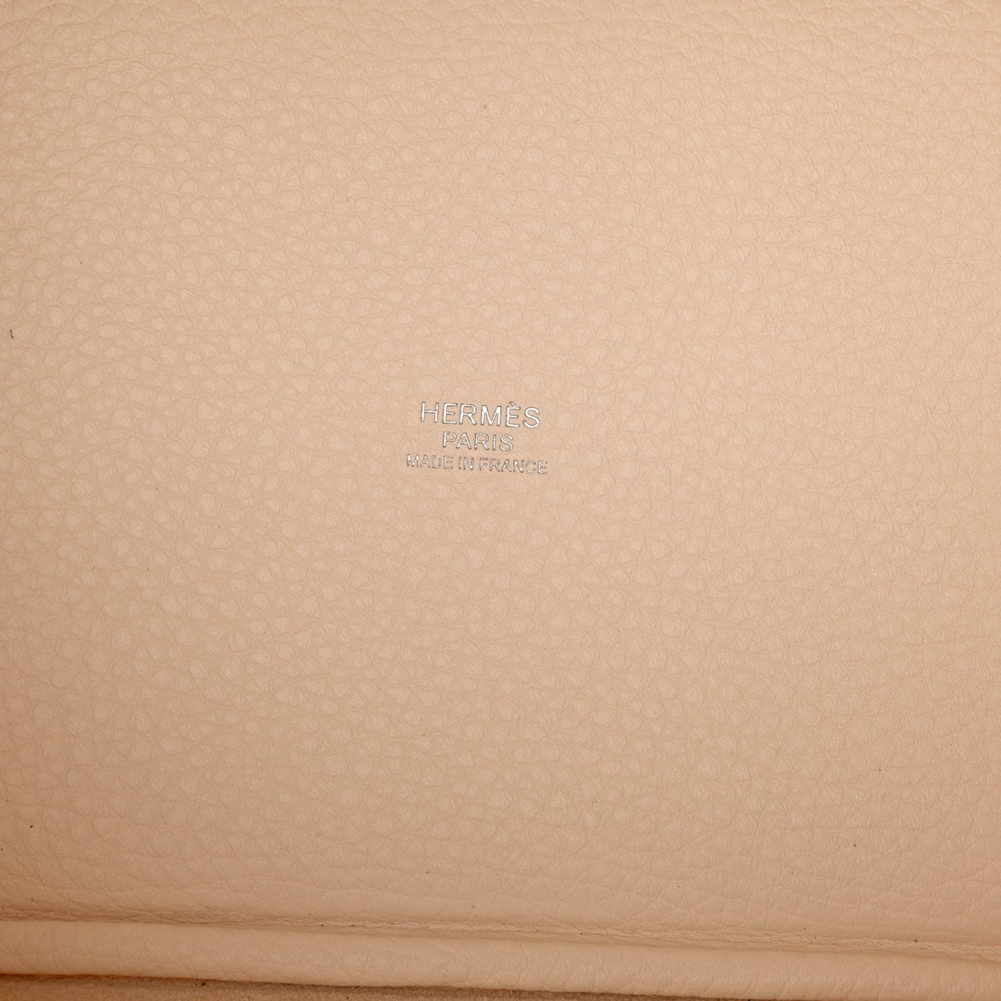 Nata leather handbag panel with embossed brand mark on textured grain