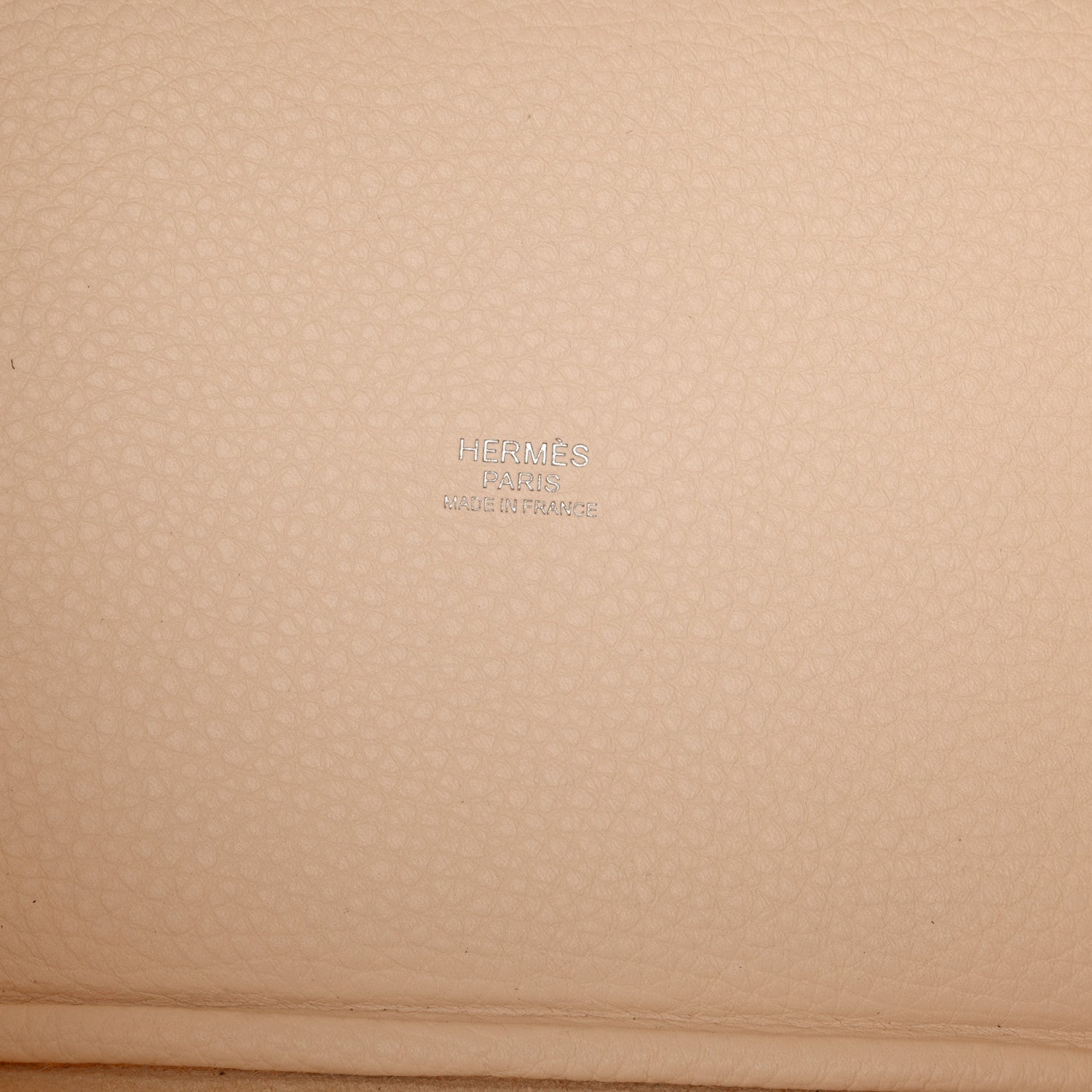 Nata leather handbag panel with embossed brand mark on textured grain