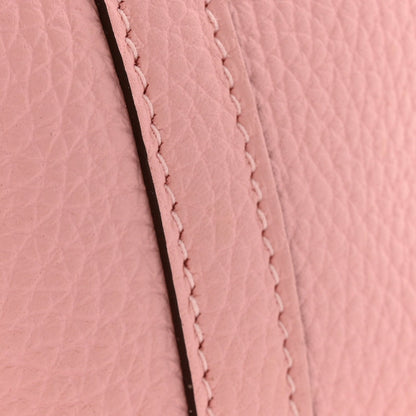 Rose pink leather seam with close-up stitched border and textured grain