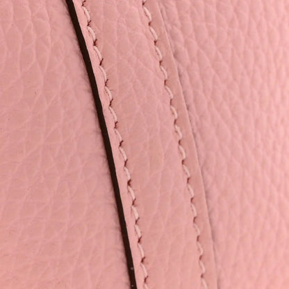 Rose pink leather seam with close-up stitched border and textured grain