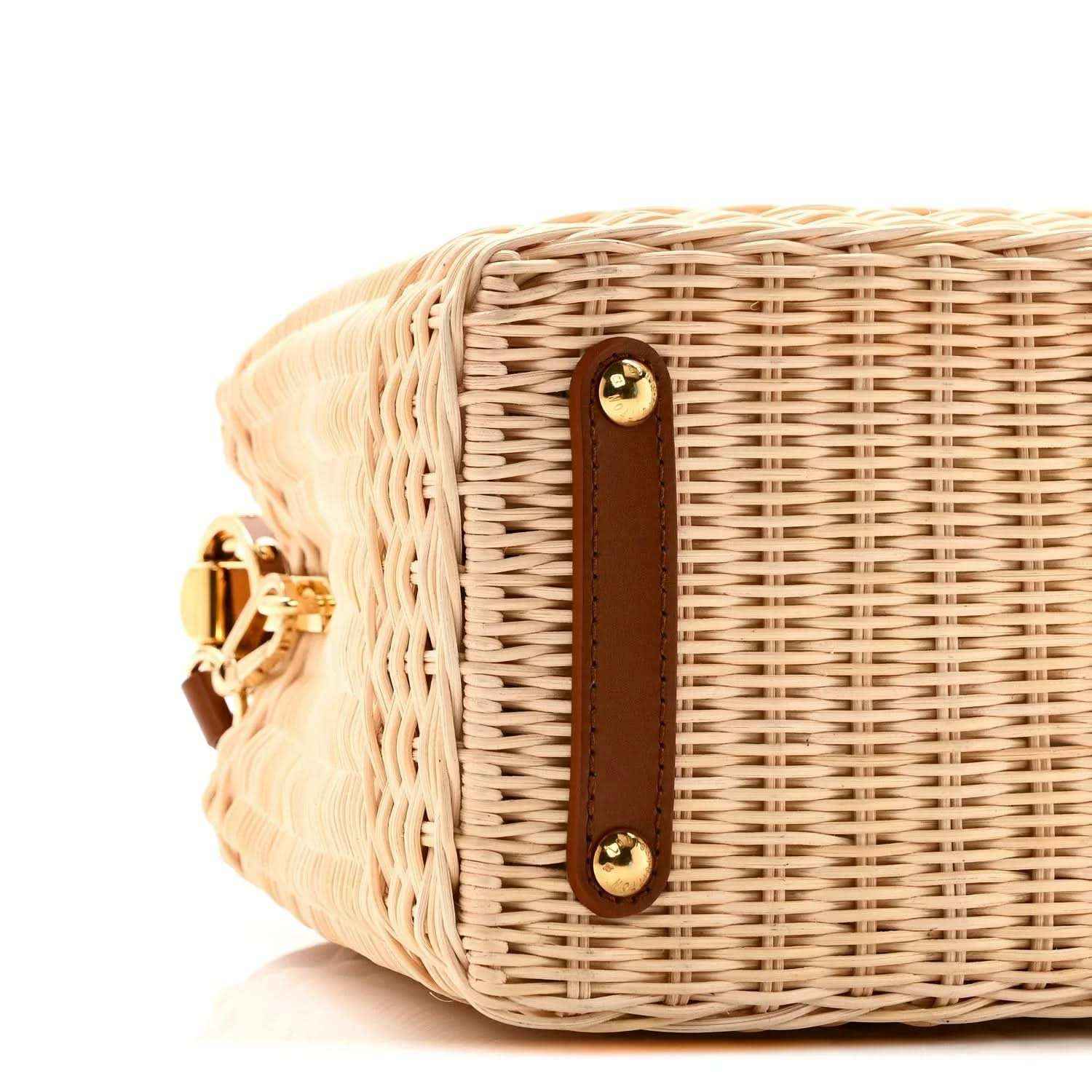 Tan rattan handbag side with brown leather trim and two gold snap buttons
