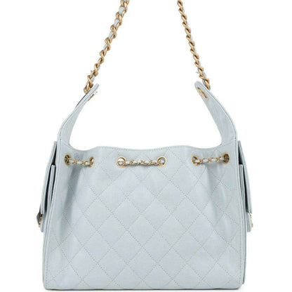 Light blue quilted caviar hobo bag with gold chain straps and front emblem charm