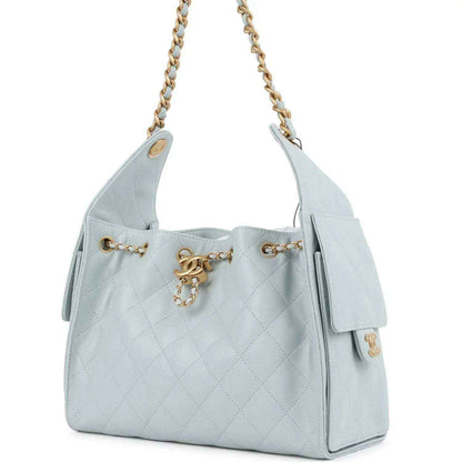 Light blue quilted caviar hobo bag with gold chain strap and side tassel detail