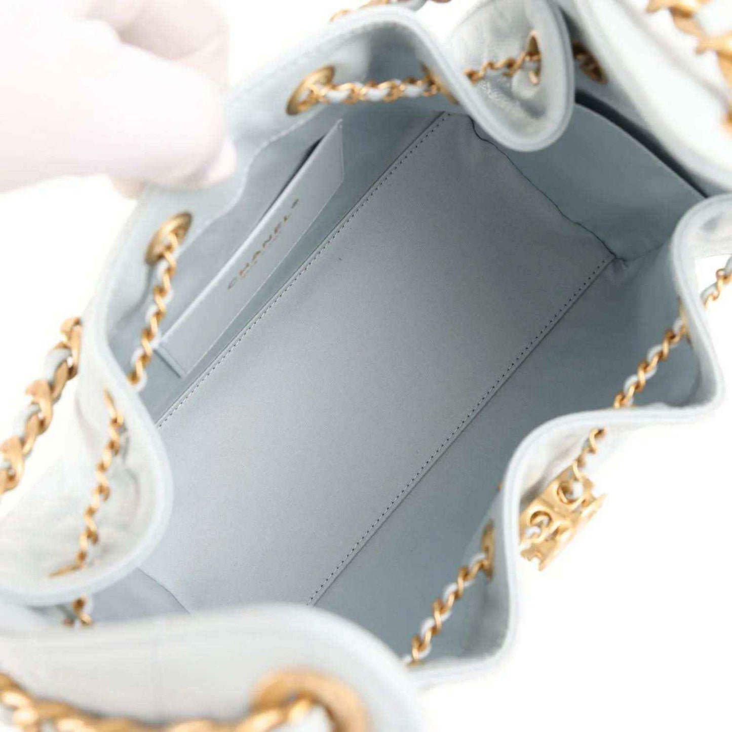 Light blue satin-lined interior of a quilted caviar hobo bag with chain strap