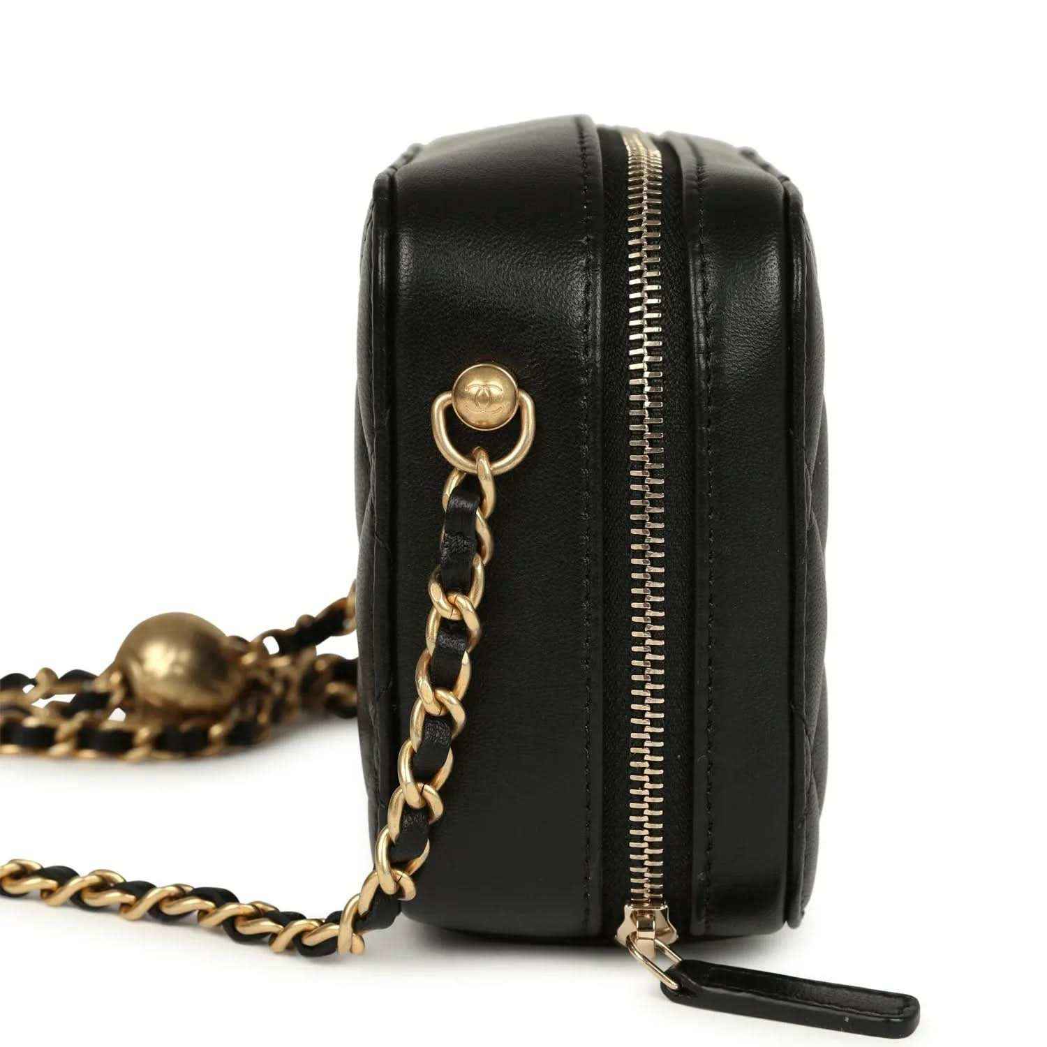 Black leather clutch closeup with gold zipper, chain strap and CC medallion clasp