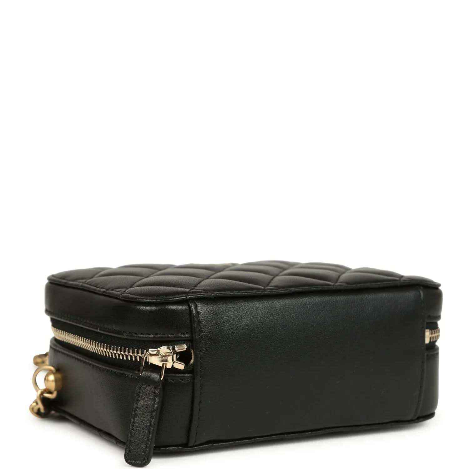 Black leather clutch with gold-tone zipper and quilted top edge, flat base