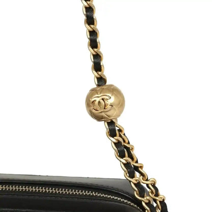 Gold-tone chain with round CC charm and black quilted mini clutch