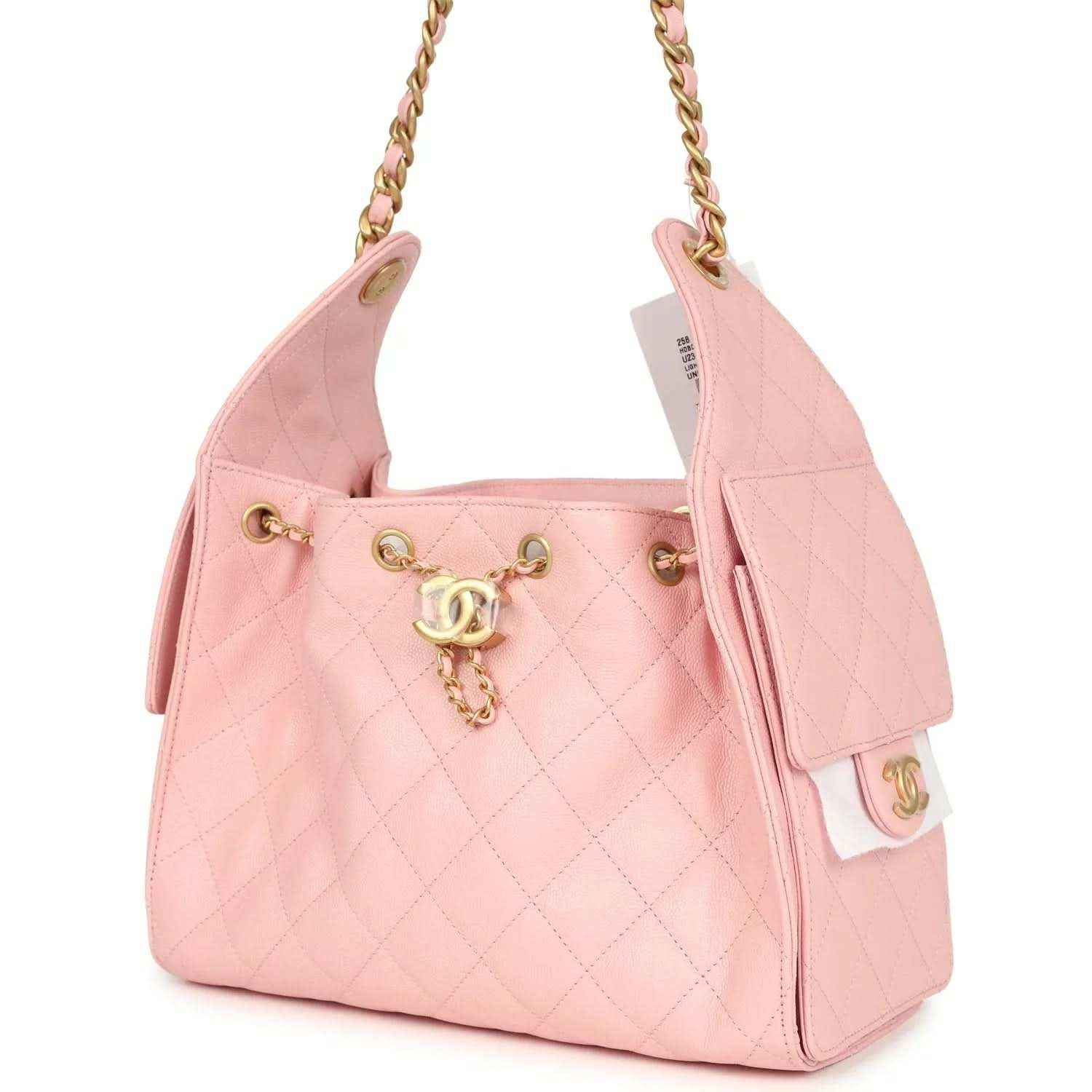 Small hobo bag light pink caviar with tassel charm, chain strap, and side flap