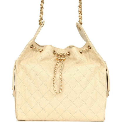 Light beige quilted caviar hobo bag with gold chain strap and drawstring toggle