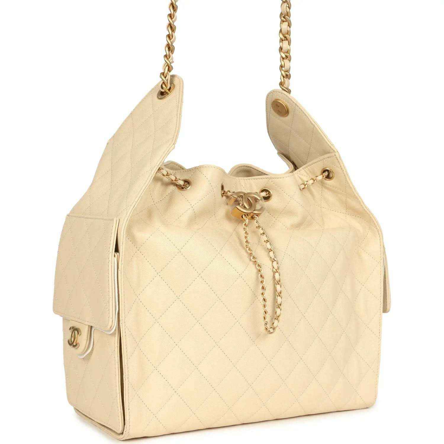 Light beige quilted caviar hobo bag side view with gold hardware and chain strap