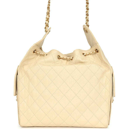Light beige quilted caviar hobo bag with gold chain handles and front drawstring