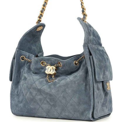 Small Chanel hobo bag in blue suede with quilted front, front flap, and gold chain strap