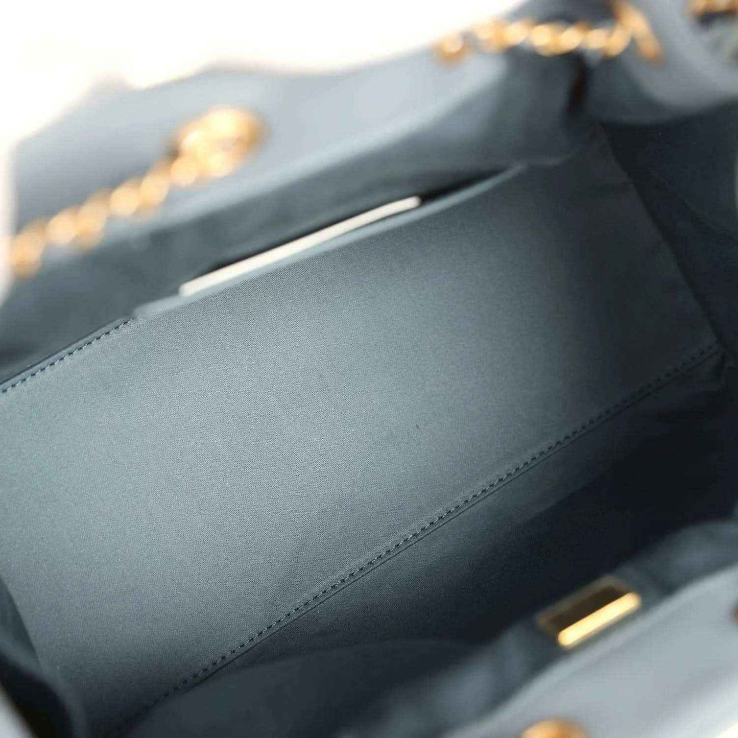 Chanel hobo bag interior lining with stitched seam and top zipper pull