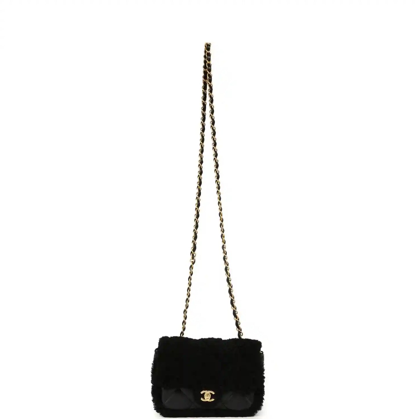Black mini flap bag with shearling and gold chain strap, quilted flap and CC clasp