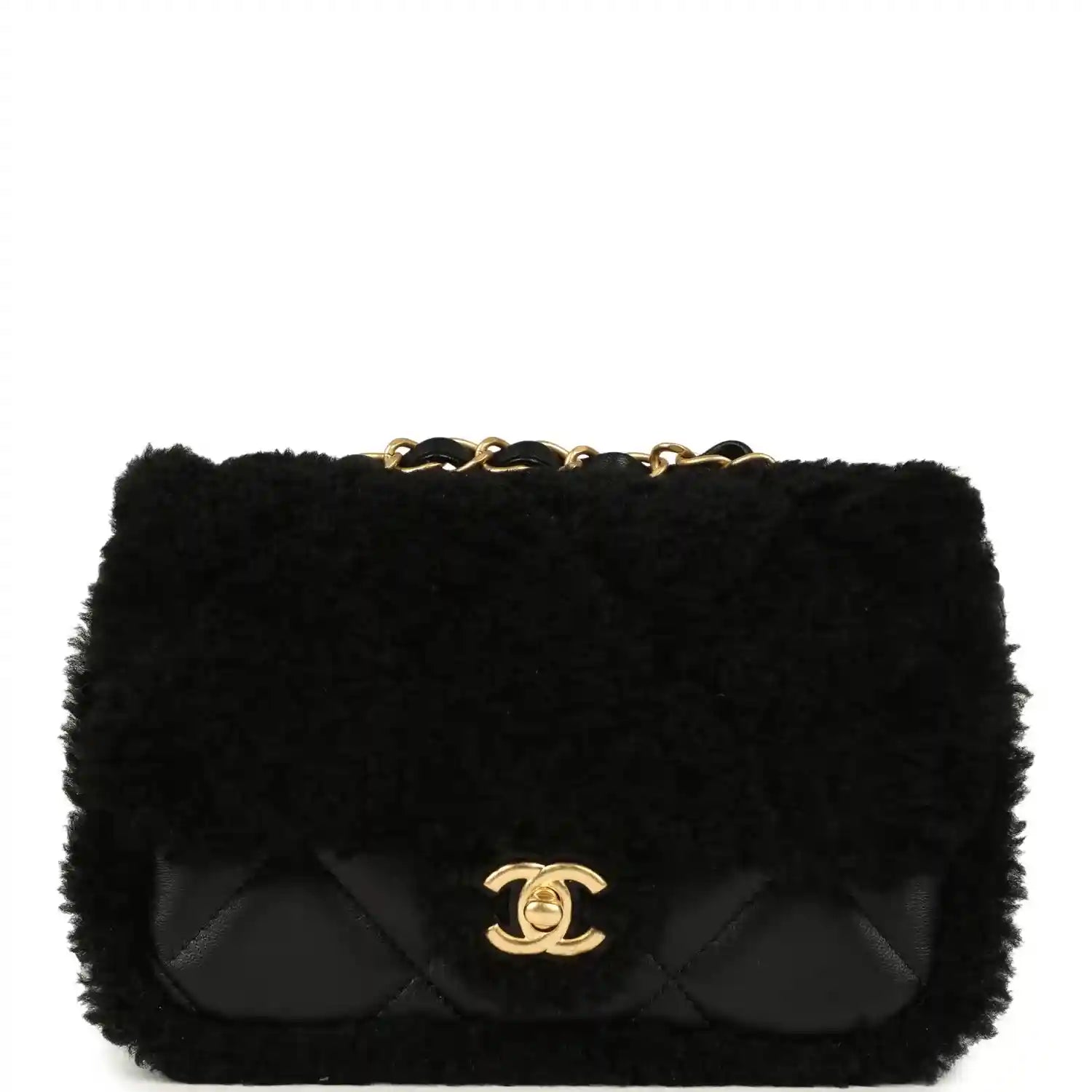 Black mini flap bag with shearling and quilted flap, gold CC logo and chain handle