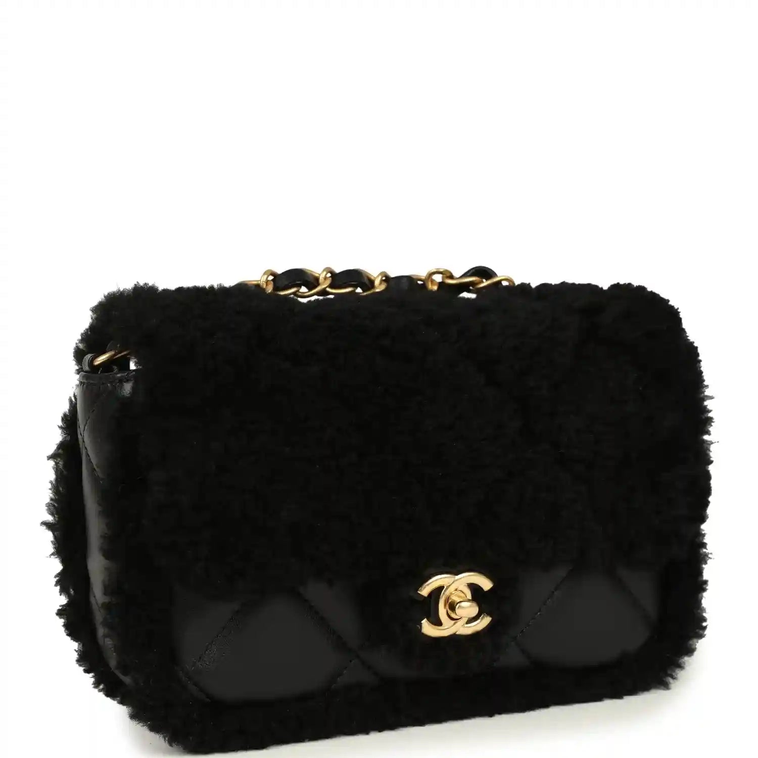 Black mini flap bag with shearling, quilted front panel and gold CC emblem, chain top