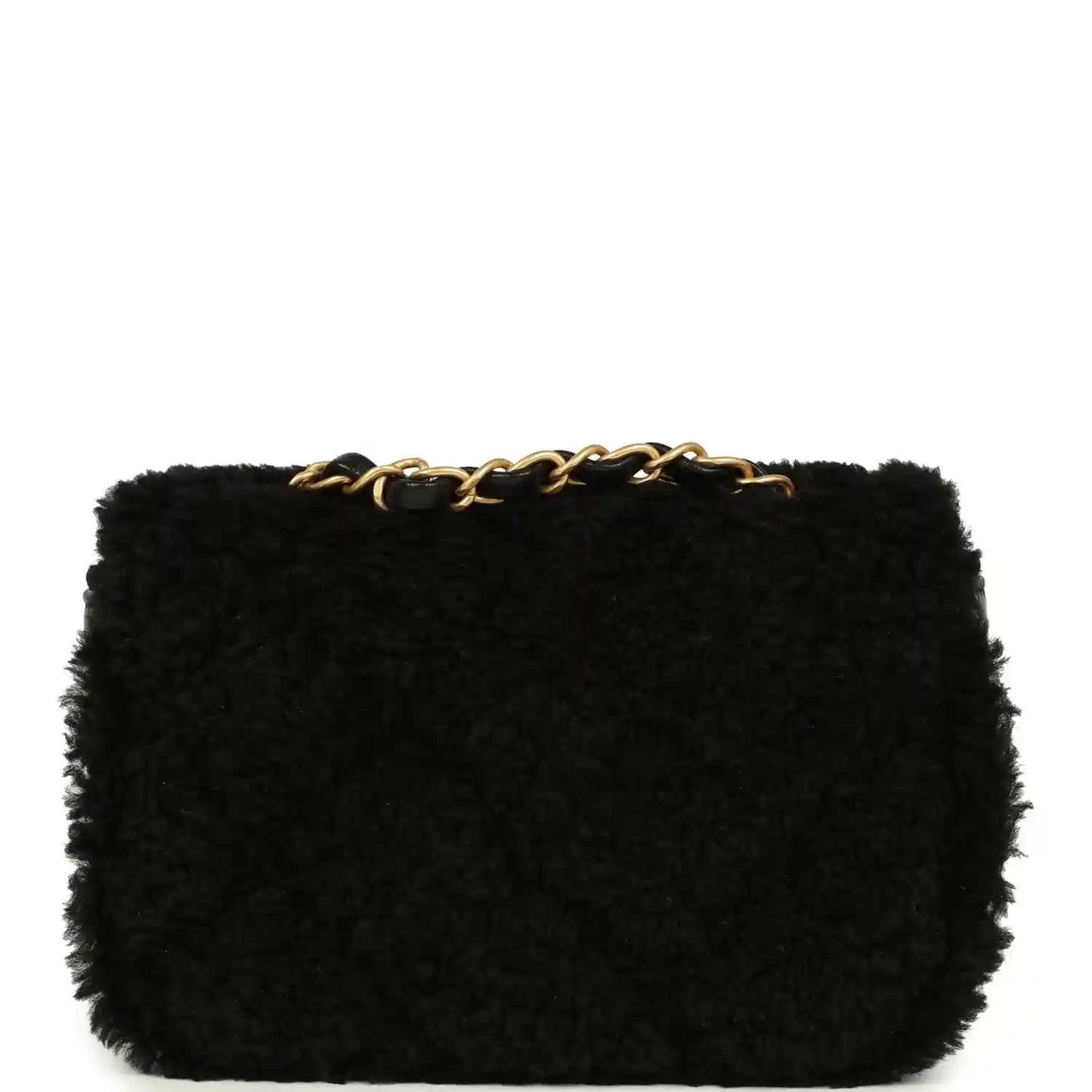 Black mini flap bag in shearling with gold chain top detail