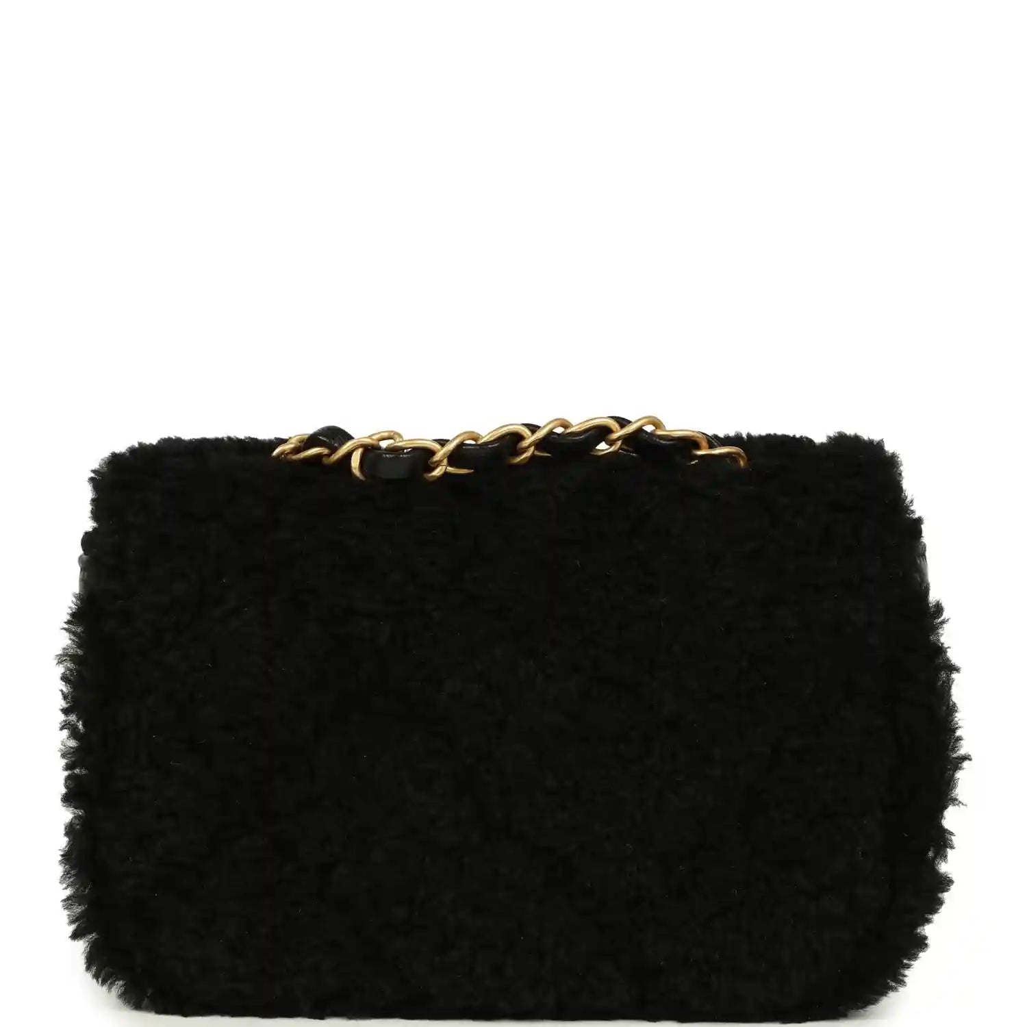 Black mini flap bag in shearling with gold chain top detail