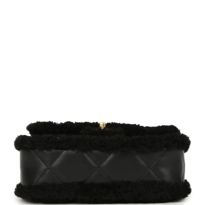 Black mini flap bag with shearling, quilted front and gold CC clasp, chain strap