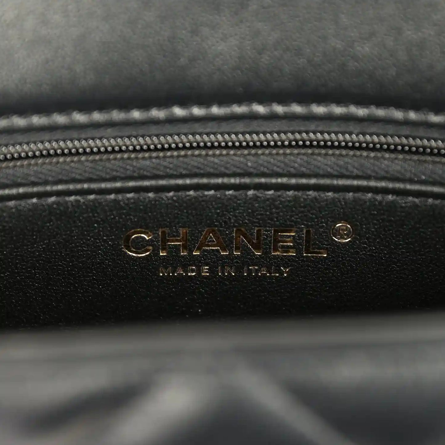 Black lambskin bag interior panel with gold CHANEL logo and zipper trim