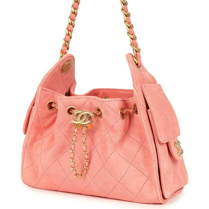 Chanel mini hobo bag in pink suede with quilted pattern, chain straps, and side buckle