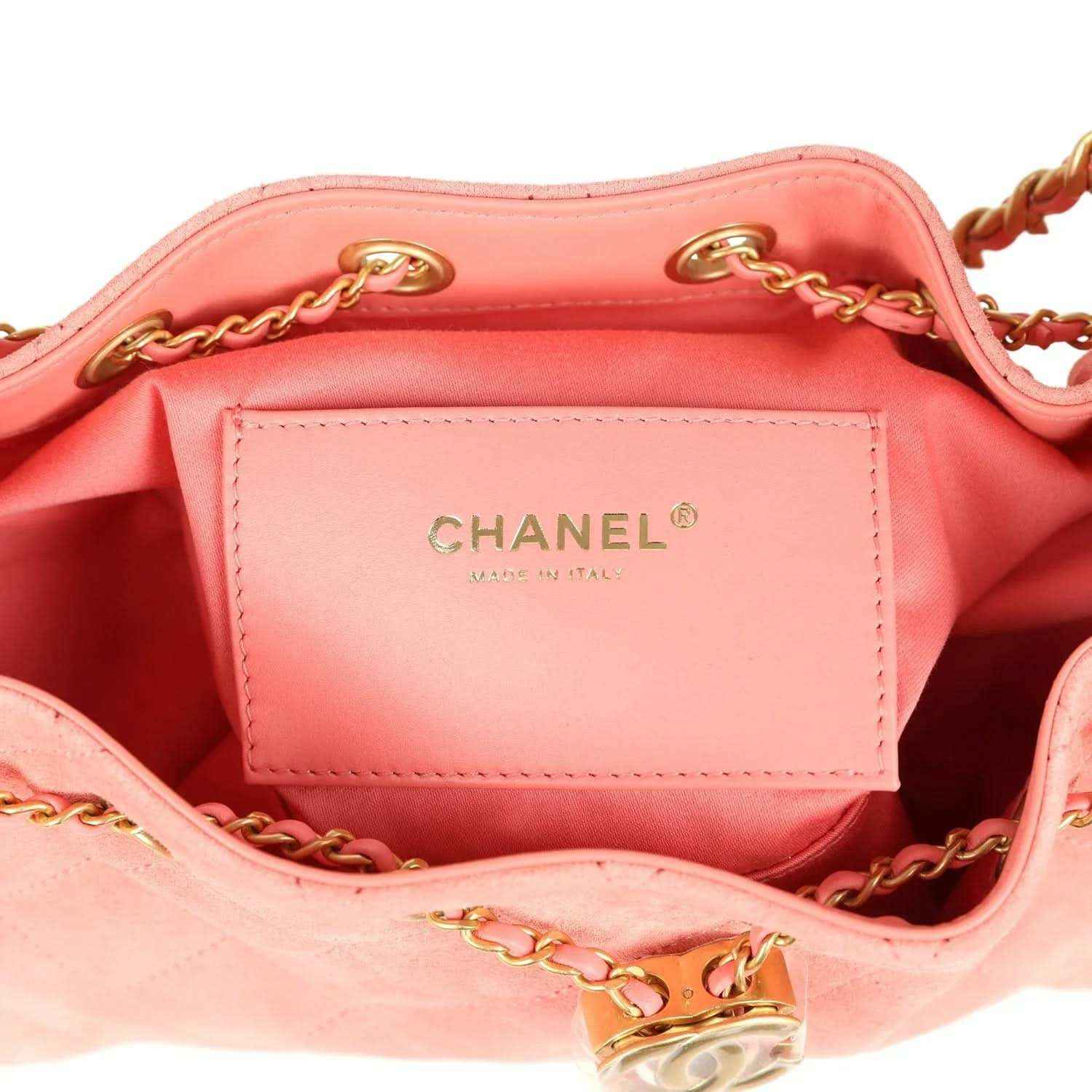 Chanel mini hobo bag lining with CHANEL logo tag, pink suede exterior, gold-tone rings
