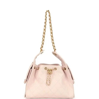 Pink quilted hobo bag with top chain handles and gold CC charm pull