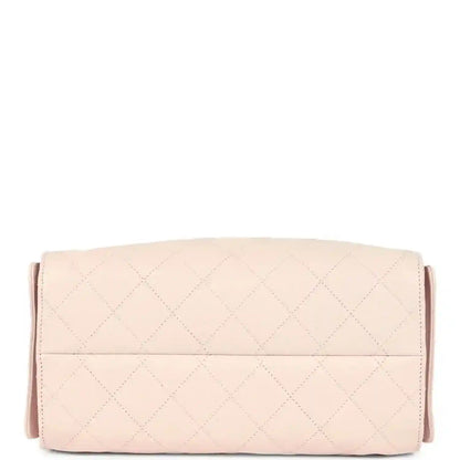 Pink quilted shoulder bag with wide flap and top stitching