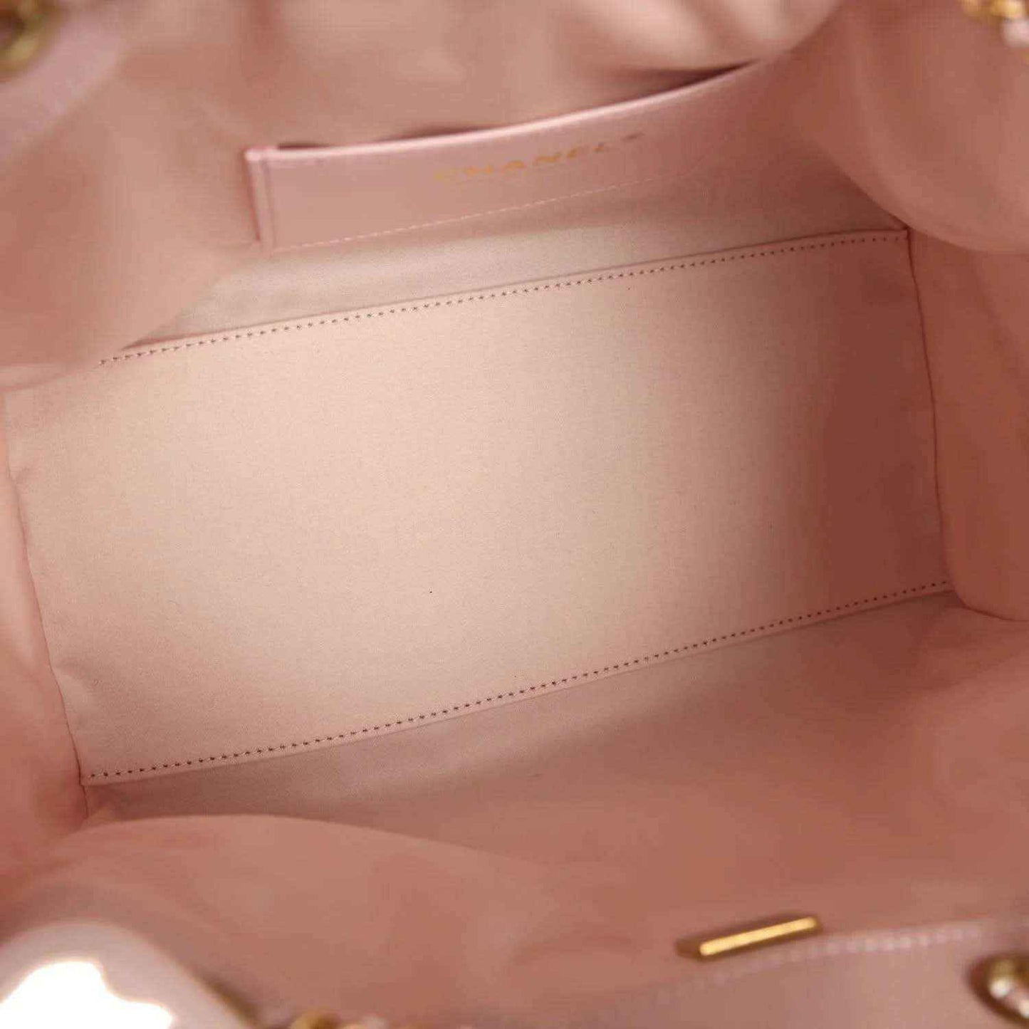 Pink hobo bag lining with stitched interior panel and small gold snap