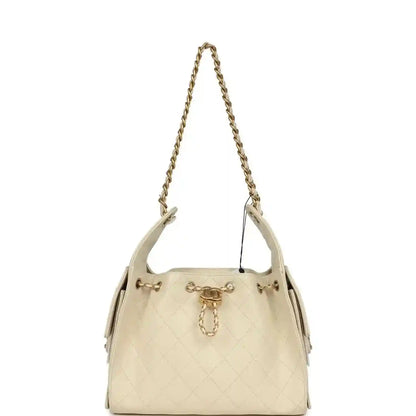Light beige caviar hobo bag with gold-tone chain shoulder straps and top hardware