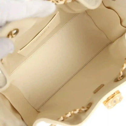 Light beige interior of hobo bag with quilted lining and gold-tone hardware