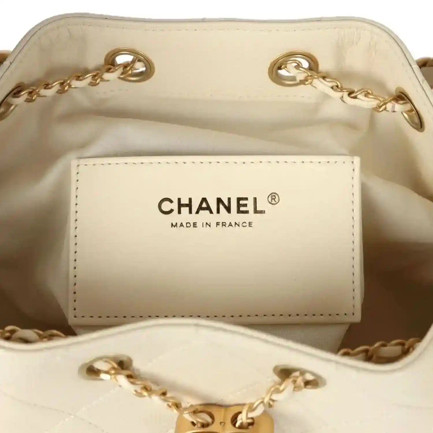 Chanel pocket label inside light beige hobo bag lining with gold-tone chain trim