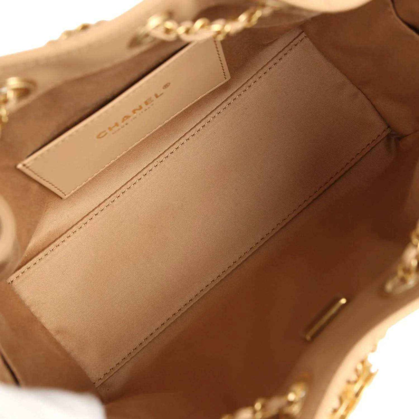 Beige interior of mini Chanel hobo bag with stitched panel and side pocket