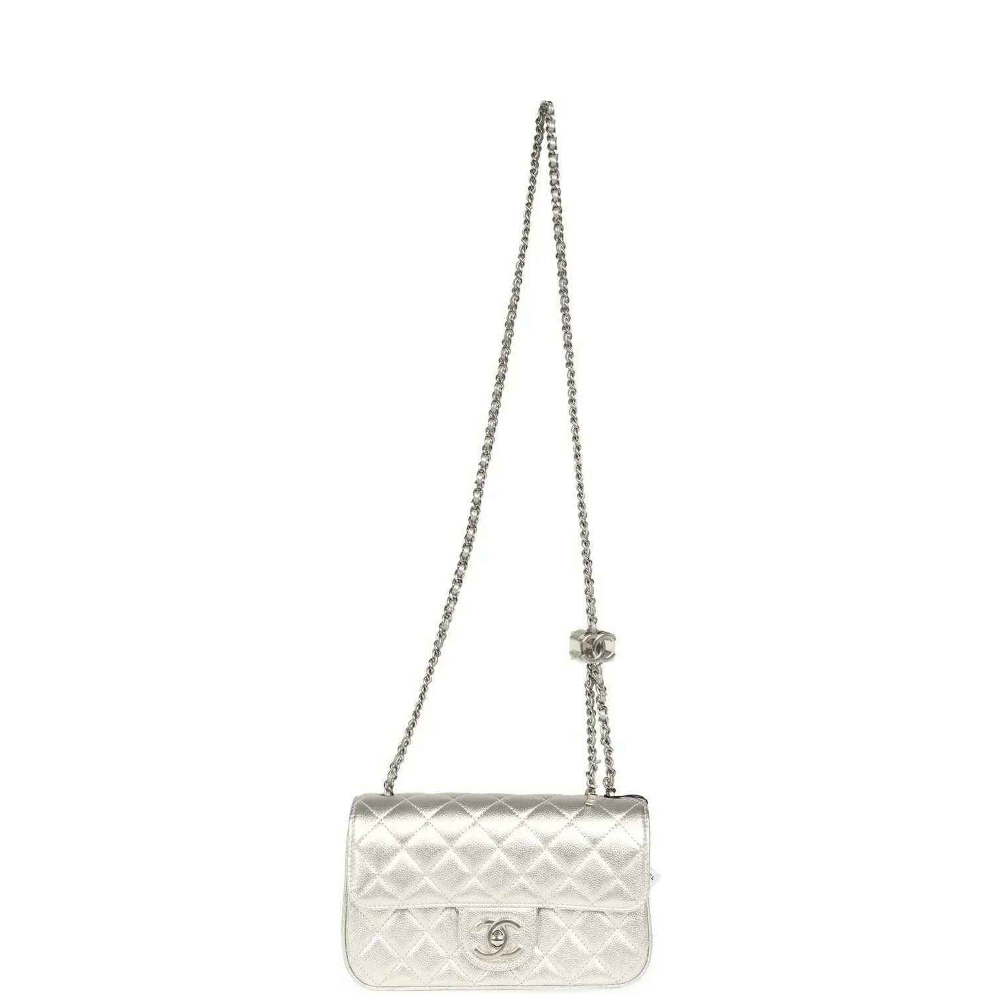 Chanel mini CC flap bag on a silver chain strap in quilted metallic leather