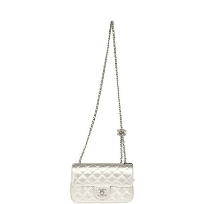Chanel mini CC flap bag on a silver chain strap in quilted metallic leather
