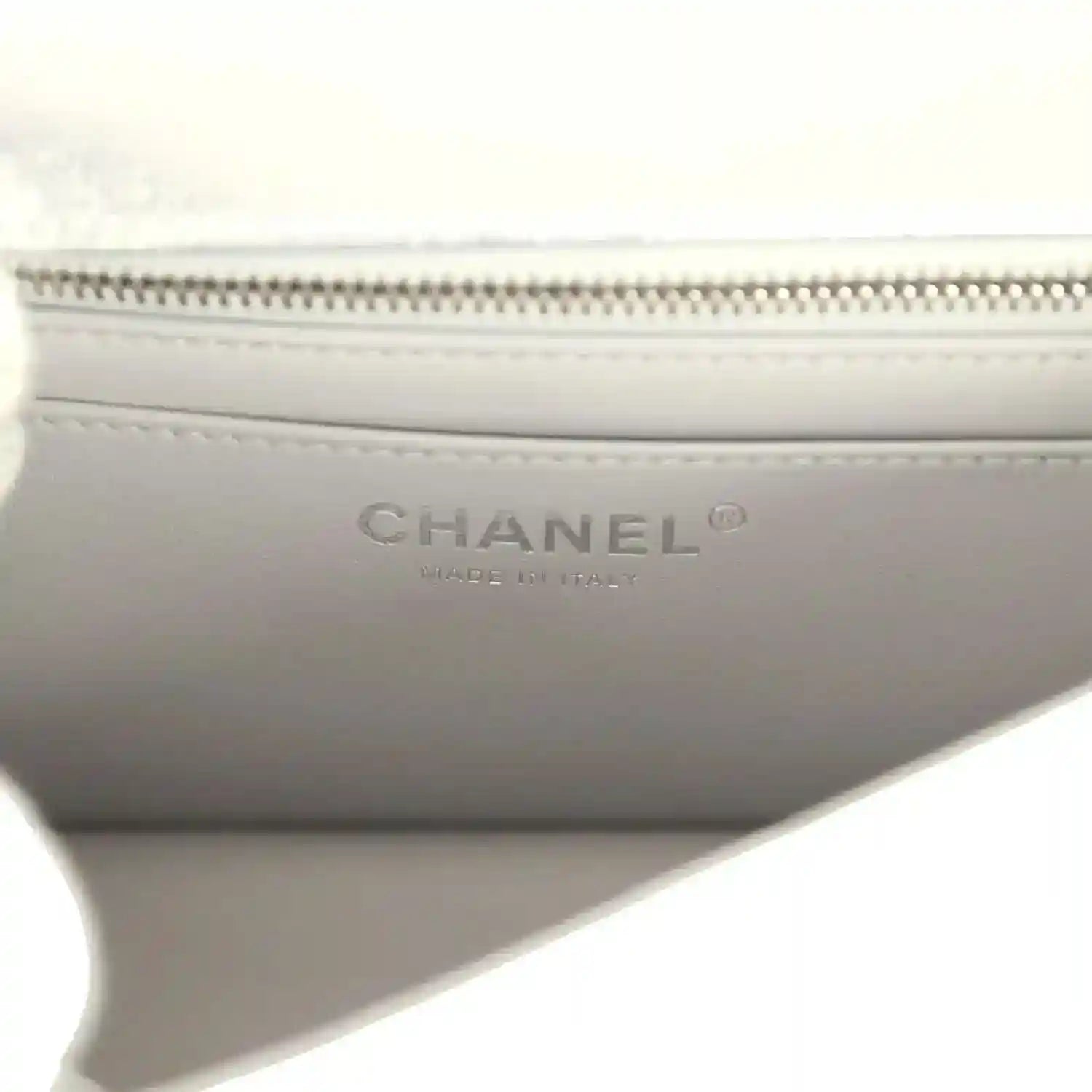 Chanel mini CC flap bag lining detail with CHANEL logo and zipper track