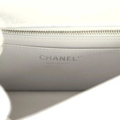 Chanel mini CC flap bag lining detail with CHANEL logo and zipper track