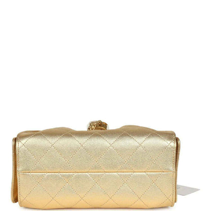 Chanel mini hobo bag in metallic gold quilted caviar with flap and clasp detail