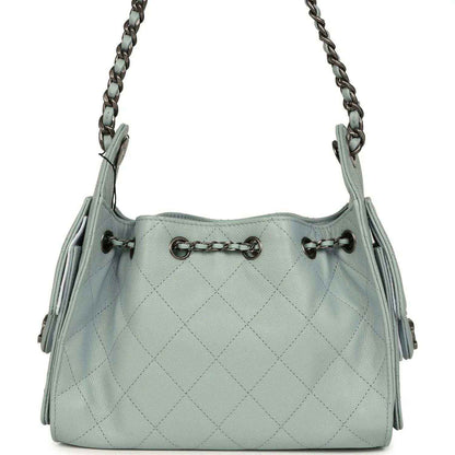 Light blue quilted mini hobo bag with chain shoulder straps and side snap pockets