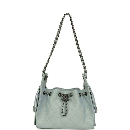 Light blue quilted mini hobo bag with chain shoulder strap and side snap tabs
