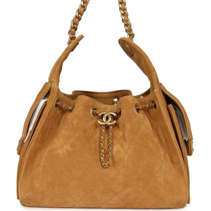 Tan suede hobo bag with antique gold chain handles and CC turn-lock charm