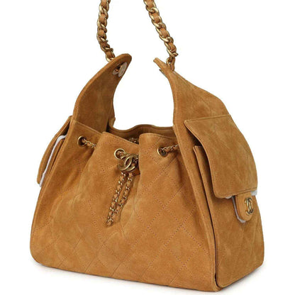 Tan suede hobo bag with drawstring cord, antique gold chain and CC charm details
